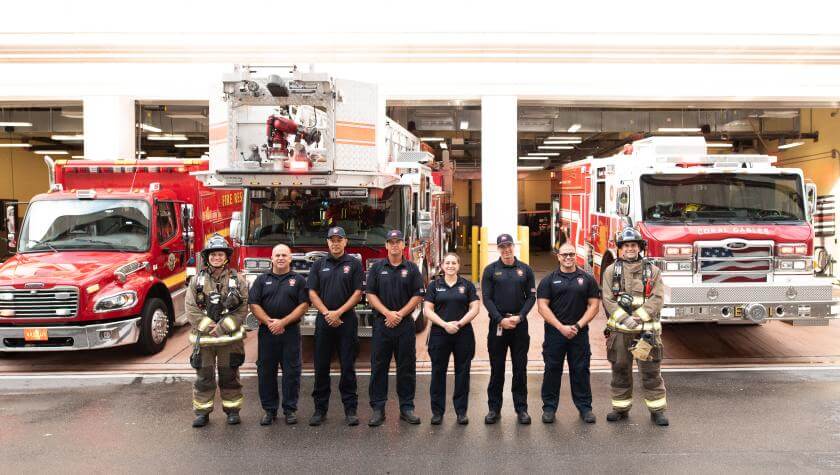 Joining the Fire Department several firefighters pose for a photo op